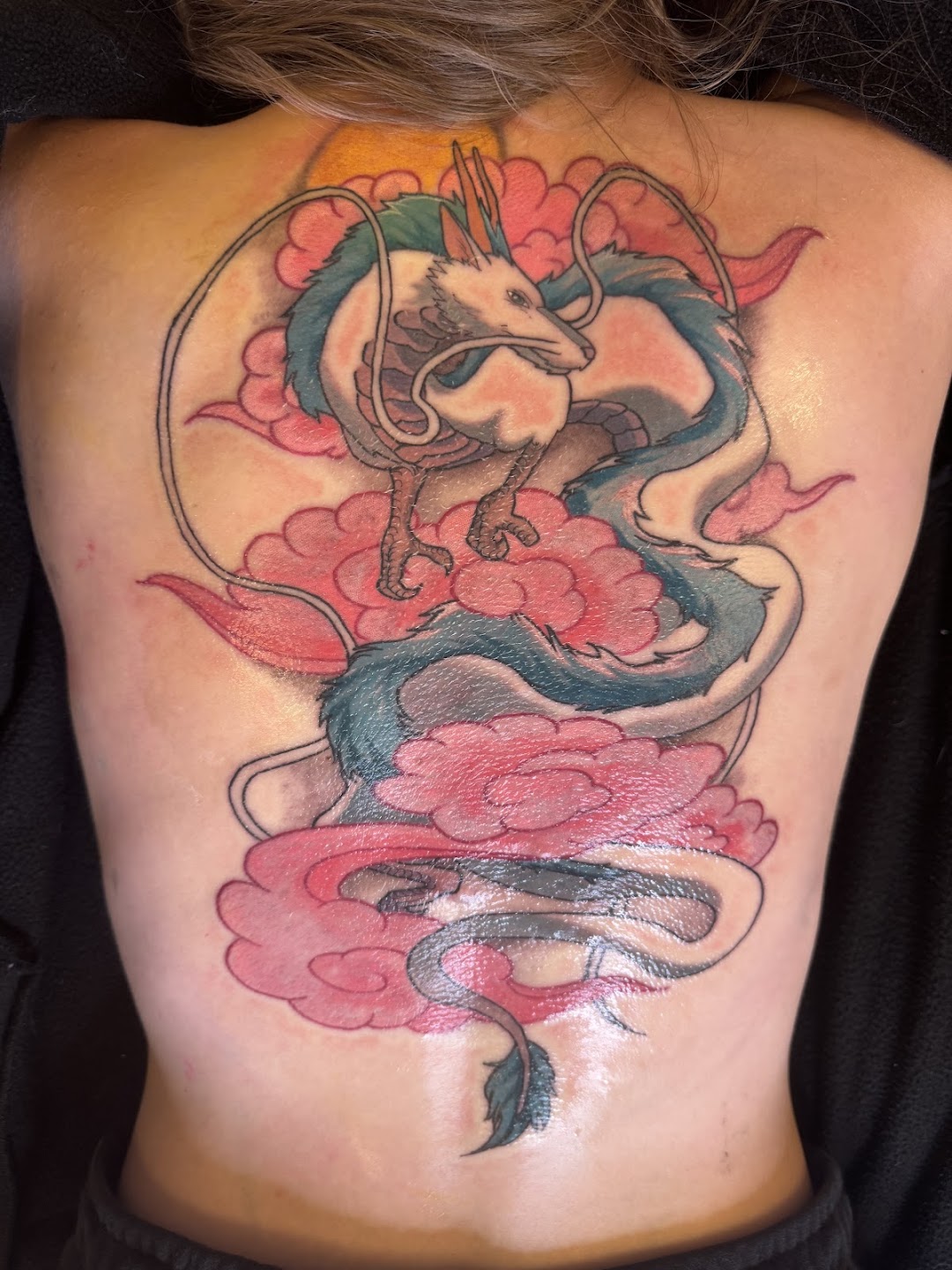 Large colorful dragon back tattoo at Anbu Tattoo Studio