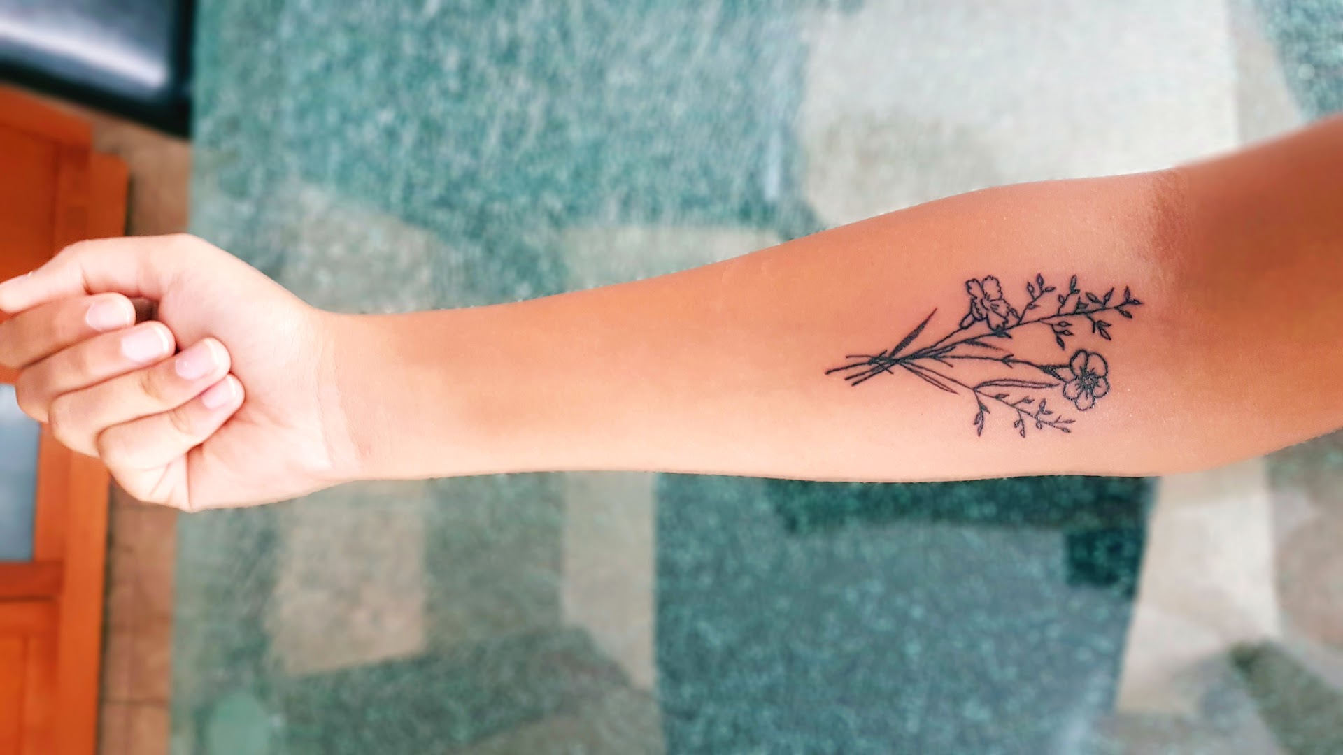 Clean floral forearm tattoo by Anbu Tattoo artists