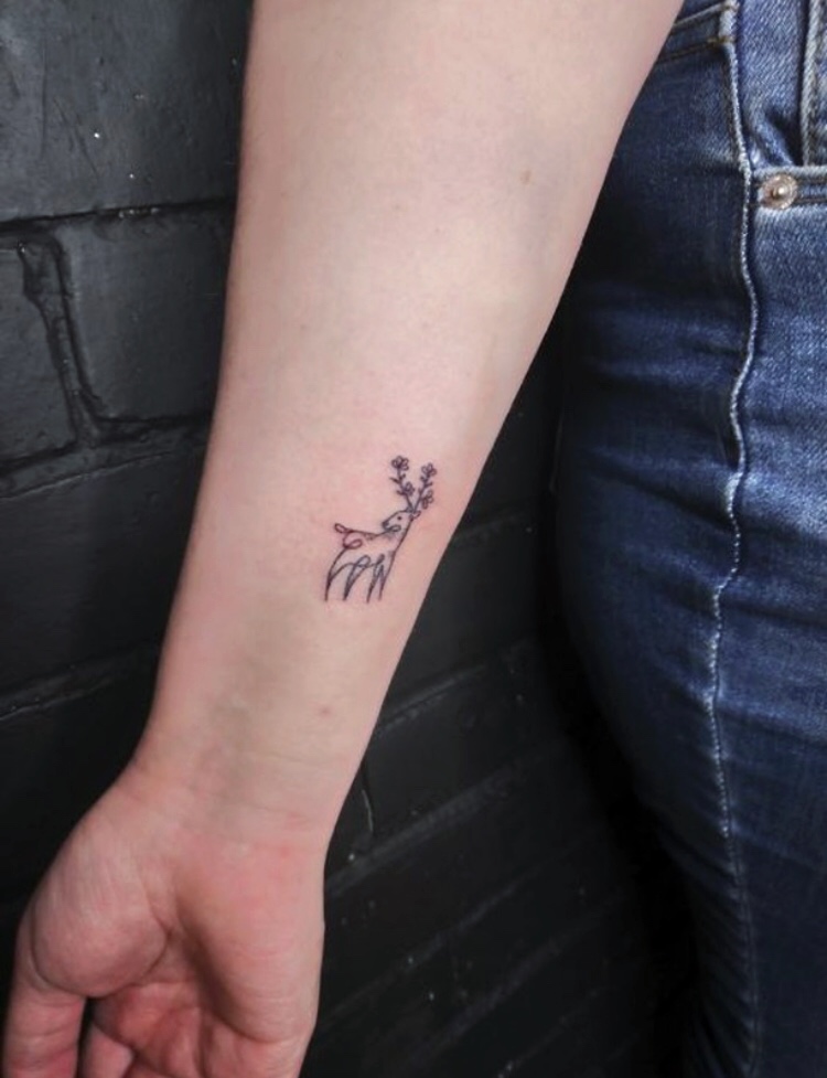 Small minimalist deer tattoo on wrist