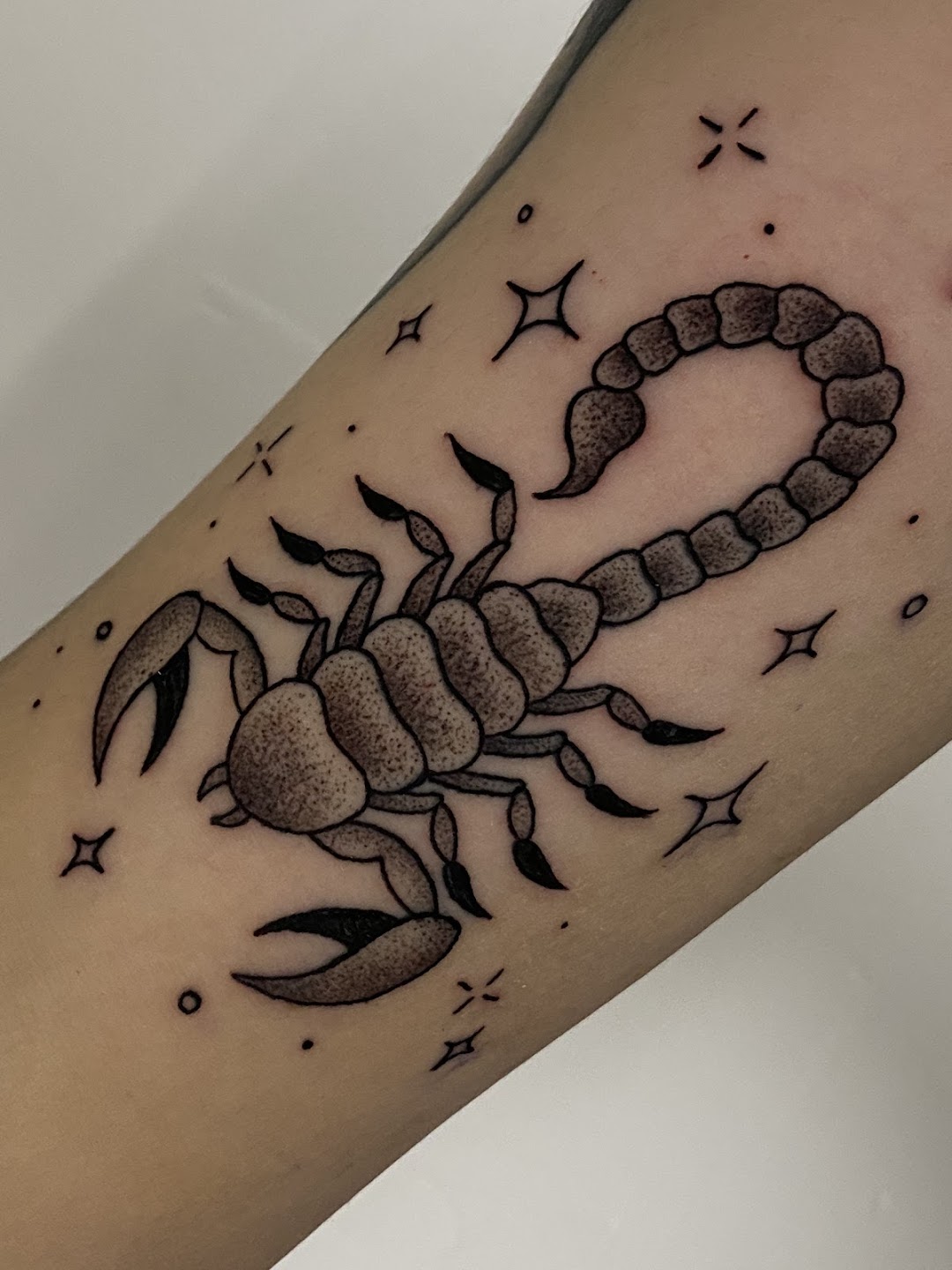 Scorpion with stars tattoo close-up